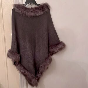 Tres luxe poncho with faux fur trim.